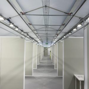 Interior view of a premium corporate marquee with bright overhead lighting.