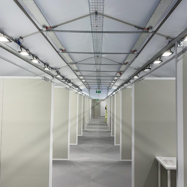 Interior view of a premium corporate marquee with bright overhead lighting.